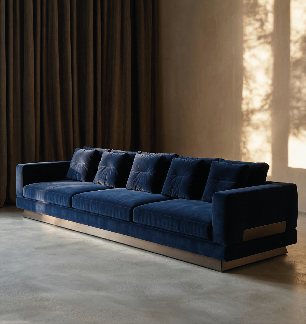 Britten Sofa – Luxurious deep blue velvet sectional with plush cushions, offering contemporary comfort and style.
