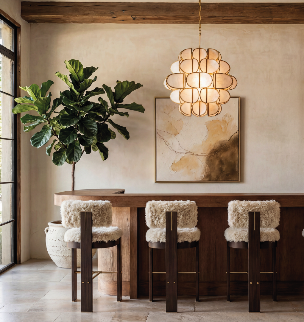 Modern kitchen with dark wood bar stools featuring cream shearling seats and brass footrests