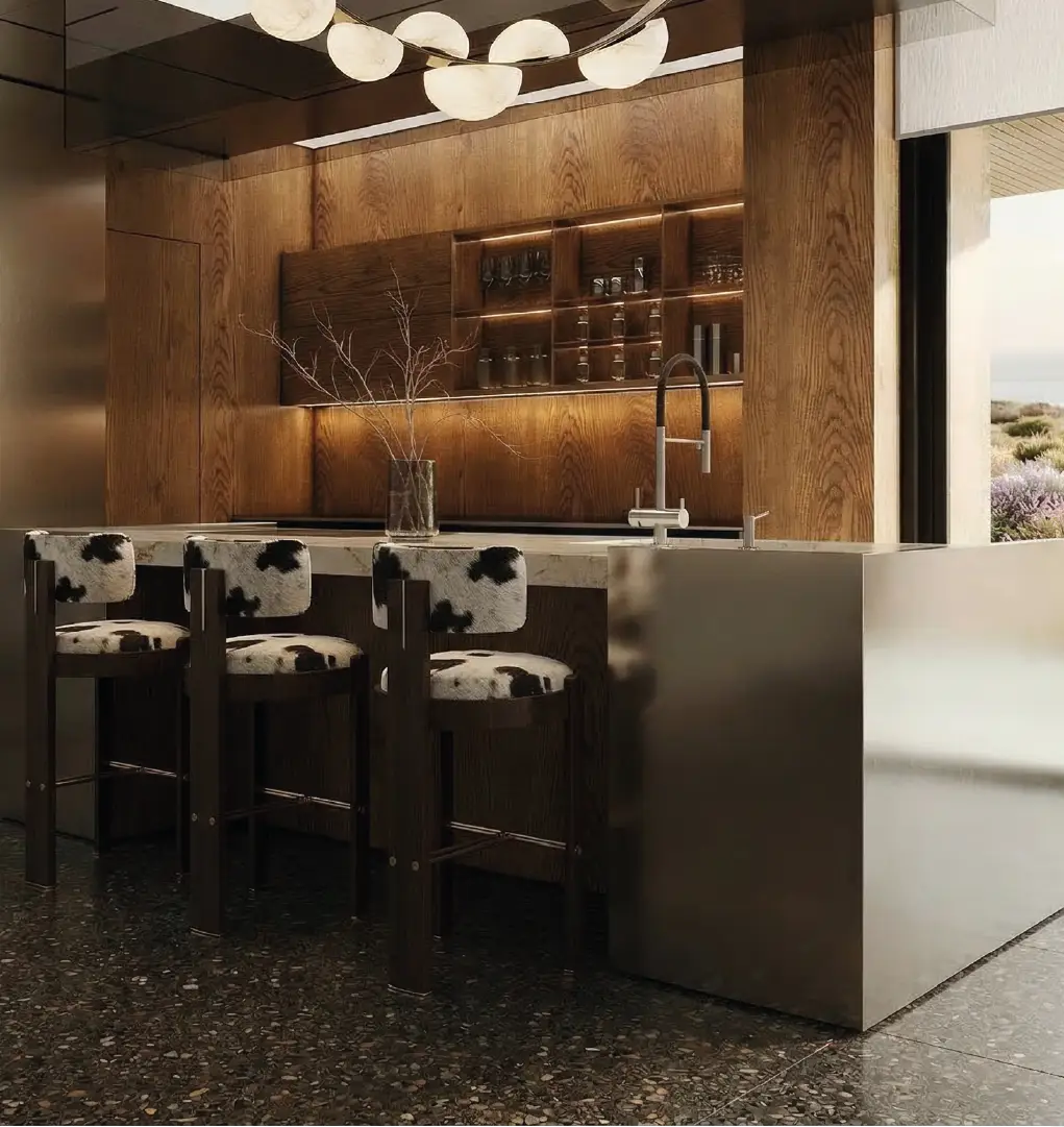 Luxury kitchen with upholstered bar stools, marble island and wood cabinetry