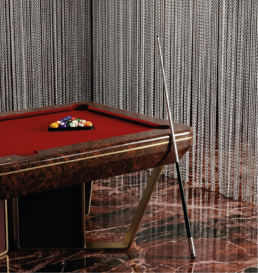 Luxury pool table with red felt in modern interior with bar and garden view