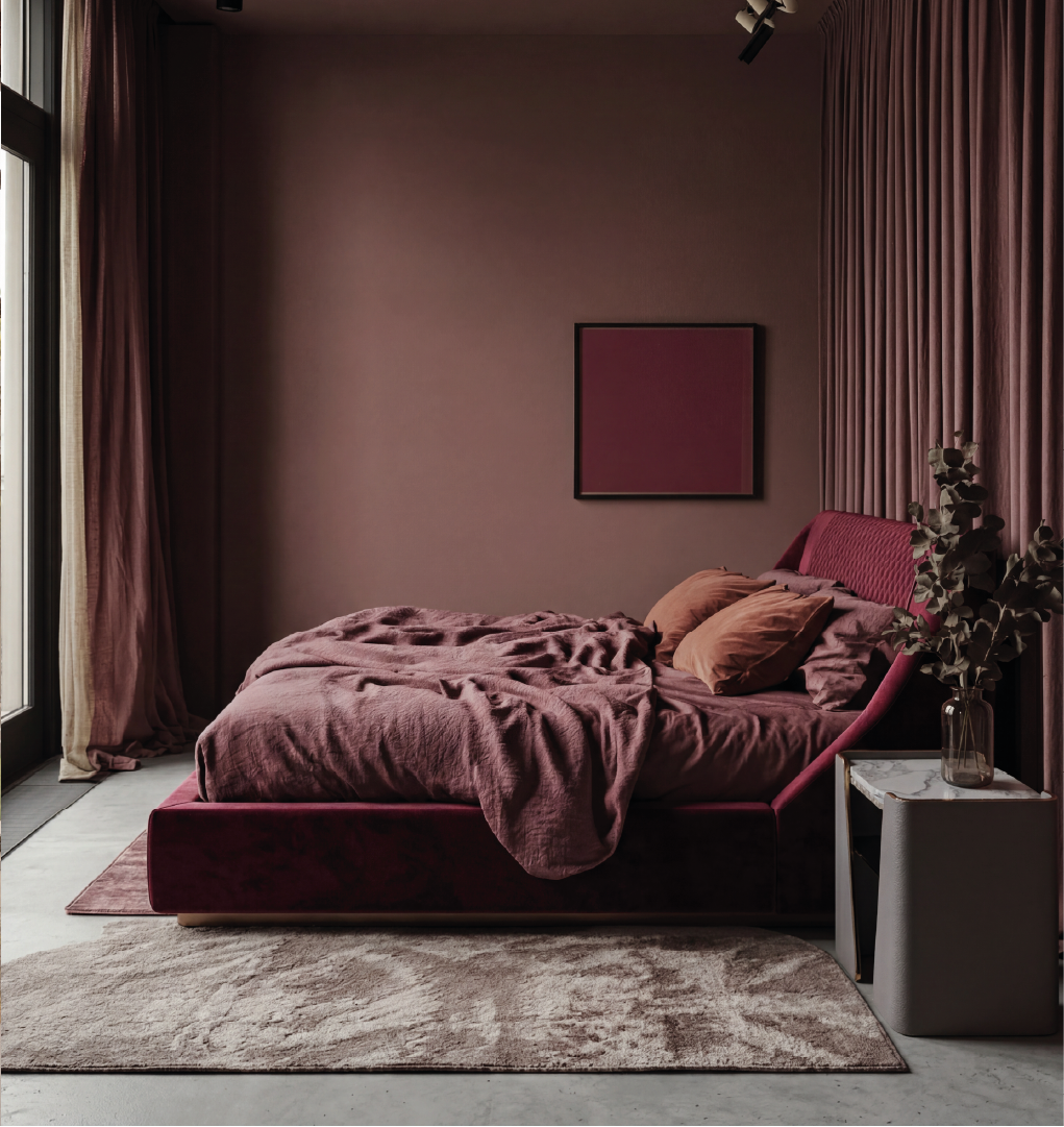Purcell upholstered bed in deep burgundy velvet with quilted headboard in a modern bedroom with warm tones and soft lighting.