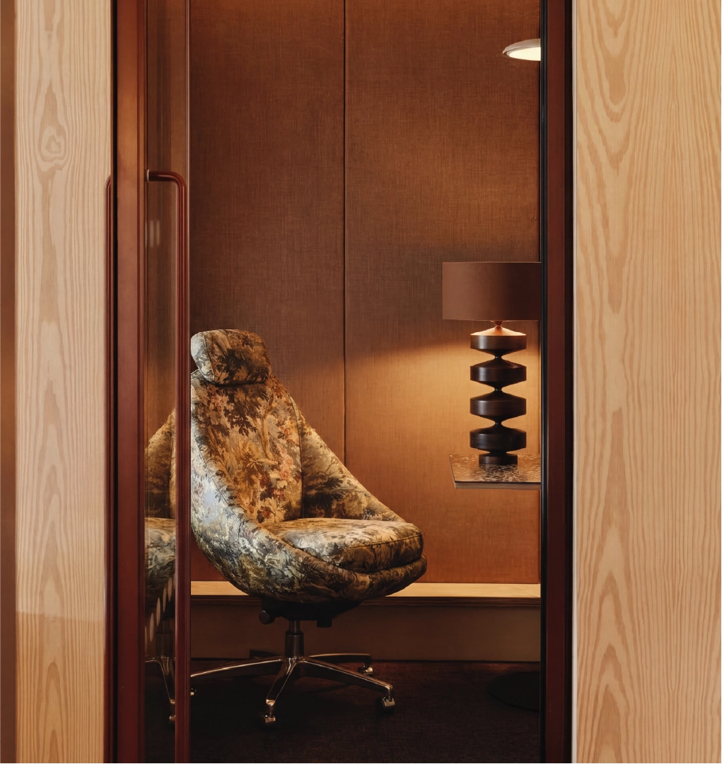 Luxury upholstered office chair in modern wood-paneled workspace