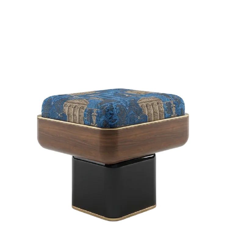 Reich stool with blue patterned upholstered seat, curved wood frame, and black pedestal base with brass detail.