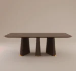 Strauss dining table with dark wood finish, sculptural tapered legs, and gold accents on a neutral background.