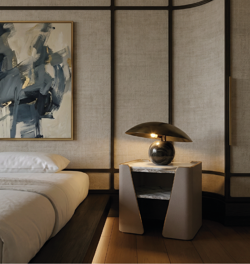 The Tallis Nightstand is a contemporary bedside piece that blends architectural design with luxurious materials. Featuring a sleek marble top, the nightstand is framed by softly curved, leather-wrapped sides that create a distinctive sculptural silhouette. An open shelf beneath the top provides practical storage while maintaining a light and airy visual profile. The combination of stone, leather, and metal accents reflects a refined modern aesthetic, making it ideal for upscale bedrooms or sophisticated interior settings. Both functional and visually striking, the Tallis Nightstand adds depth, texture, and elegance to any space.