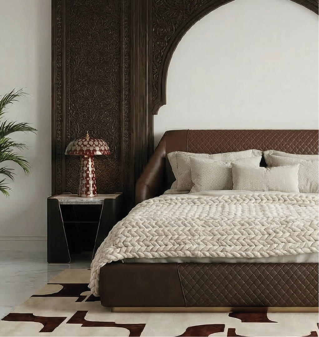 Tallis nightstand with marble top and leather sides beside upholstered bed in luxury bedroom.