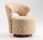 Luxury accent chair with cream and gold patterned upholstery and walnut root wood base