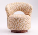 Luxury accent chair with cream and gold patterned upholstery and walnut root wood base