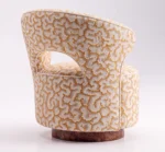 Luxury accent chair with cream and gold patterned upholstery and walnut root wood base
