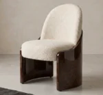 Fauré dining chair with cream bouclé upholstery and curved walnut root wood side panels