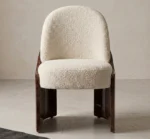 Fauré dining chair with cream bouclé upholstery and curved walnut root wood side panels