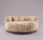 Hedy chaise lounge in cream and gold botanical upholstery with rounded silhouette and dark walnut wood base